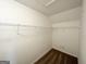 Walk-in closet provides ample storage with wall-mounted shelving and neutral carpeting at 6861 John Clark Dr, Douglasville, GA 30134
