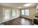 Bright dining area featuring wood floors and sliding glass door leading to the outside at 6861 John Clark Dr, Douglasville, GA 30134