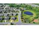 Beautiful aerial view of a home with manicured lawn in a peaceful neighborhood with a pond at 7575 Old Camp Lndg, Cumming, GA 30040