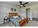 Bedroom features ceiling fan, natural light, and warm-toned wood bed frame at 7575 Old Camp Lndg, Cumming, GA 30040