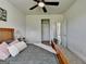 Bedroom featuring a ceiling fan, neutral walls, and a door leading to the closet at 7575 Old Camp Lndg, Cumming, GA 30040