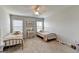Bedroom featuring two twin beds with metallic frames, a vanity, and a ceiling fan at 7575 Old Camp Lndg, Cumming, GA 30040