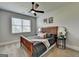 Bedroom features ceiling fan, natural light, and warm-toned wood bed frame at 7575 Old Camp Lndg, Cumming, GA 30040