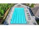 A high-angle view displays a clear swimming pool with neatly arranged lounge chairs and ample space at 7575 Old Camp Lndg, Cumming, GA 30040