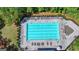 Aerial view shows a pristine pool with lounge chairs, perfect for relaxation in a green environment at 7575 Old Camp Lndg, Cumming, GA 30040