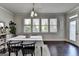 Bright dining room featuring modern table set, dark wood floors, and large window at 7575 Old Camp Lndg, Cumming, GA 30040