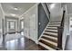 View of the foyer with dark wood floors and a staircase with black wrought iron spindles at 7575 Old Camp Lndg, Cumming, GA 30040