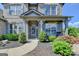 Charming home entrance featuring a covered porch and beautifully landscaped garden at 7575 Old Camp Lndg, Cumming, GA 30040