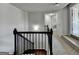 Upstairs hallway with carpet and wrought iron banister at 7575 Old Camp Lndg, Cumming, GA 30040
