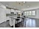 Bright kitchen boasts stainless steel appliances, island with barstool seating, and modern backsplash at 7575 Old Camp Lndg, Cumming, GA 30040