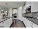 Bright kitchen boasts stone backsplash and stainless steel appliances at 7575 Old Camp Lndg, Cumming, GA 30040