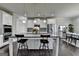 Kitchen island with barstool seating, stainless steel appliances and pendant lighting at 7575 Old Camp Lndg, Cumming, GA 30040