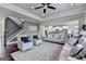 Spacious living room boasts hardwood floors, ample seating, ceiling fan, open floor plan at 7575 Old Camp Lndg, Cumming, GA 30040