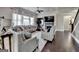 Spacious living room boasts hardwood floors, large TV over fireplace and ample seating at 7575 Old Camp Lndg, Cumming, GA 30040