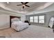Spacious carpeted main bedroom featuring a tray ceiling and paneled headboard at 7575 Old Camp Lndg, Cumming, GA 30040