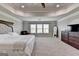 Spacious carpeted main bedroom featuring a tray ceiling and paneled headboard at 7575 Old Camp Lndg, Cumming, GA 30040