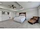 Spacious carpeted main bedroom featuring a tray ceiling and paneled headboard at 7575 Old Camp Lndg, Cumming, GA 30040