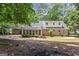 Back exterior view of home, with a patio area and large backyard with mature trees at 1680 Huntington Dr, Marietta, GA 30066