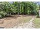 Large backyard surrounded by mature trees offers lots of privacy and space to enjoy at 1680 Huntington Dr, Marietta, GA 30066