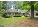 Charming home with a well-manicured lawn, inviting front porch, and mature trees at 1680 Huntington Dr, Marietta, GA 30066