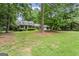 Lovely home nestled among mature trees, showcasing its charming curb appeal and inviting ambiance at 1680 Huntington Dr, Marietta, GA 30066