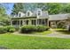 Inviting home featuring a covered front porch, lush landscaping, and charming curb appeal at 1680 Huntington Dr, Marietta, GA 30066