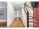 Welcoming foyer showcasing gleaming hardwood floors, staircase, and classic wainscoting details at 1680 Huntington Dr, Marietta, GA 30066