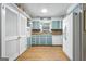 The kitchen has blue cabinets, wood floors, and white appliances at 1680 Huntington Dr, Marietta, GA 30066