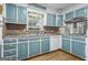 This kitchen features blue cabinets, wood floors, and modern appliances at 1680 Huntington Dr, Marietta, GA 30066