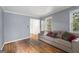 Bright living room featuring hardwood floors and ample natural light from the large window at 1680 Huntington Dr, Marietta, GA 30066