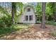 Exterior view of a shed in the backyard, surrounded by lush greenery and mature trees at 1680 Huntington Dr, Marietta, GA 30066