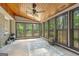 Bright sunroom featuring wood ceiling, large windows with backyard view and a ceiling fan at 1680 Huntington Dr, Marietta, GA 30066
