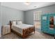 Bright bedroom with a patterned quilt and colorful dresser at 3725 Concord Rd, Newborn, GA 30056