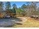 Long driveway with covered parking and plenty of space for vehicles and equipment at 3725 Concord Rd, Newborn, GA 30056