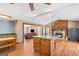 Open-concept kitchen with wood floors, an island, stone fireplace and view into the living room at 3725 Concord Rd, Newborn, GA 30056
