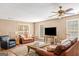 Comfortable living room with plush seating, ceiling fan, and natural light at 3725 Concord Rd, Newborn, GA 30056