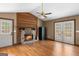 Living room features a stone fireplace, hardwood floors, and natural light at 3725 Concord Rd, Newborn, GA 30056