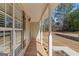 Covered porch with wood floors, columns, and natural light at 3725 Concord Rd, Newborn, GA 30056