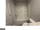 This bathroom has a shower over tub, a white tub and a gray countertop at 35 Emerald Ln # 14, Covington, GA 30014