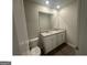 This bathroom has a double sink vanity, a toilet, and vinyl plank flooring at 35 Emerald Ln # 14, Covington, GA 30014