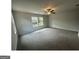 Spacious carpeted bedroom with a ceiling fan and natural light from large windows at 35 Emerald Ln # 14, Covington, GA 30014