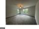 Large bedroom featuring soft carpet, ceiling fan, and well-lit with multiple windows at 35 Emerald Ln # 14, Covington, GA 30014