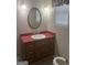 Powder room features an oval mirror and vintage lighting at 871 Clearwater Rd, Sharpsburg, GA 30277