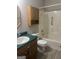 Bathroom with wood cabinets, a shower/tub combo and vinyl flooring at 871 Clearwater Rd, Sharpsburg, GA 30277