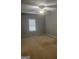 Bedroom featuring neutral carpet, a ceiling fan, and lots of natural light at 871 Clearwater Rd, Sharpsburg, GA 30277