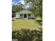Charming single-story home with a spacious front yard, inviting porch, and classic architectural details at 871 Clearwater Rd, Sharpsburg, GA 30277