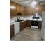 Traditional kitchen with white appliances, oak cabinets and light countertops at 871 Clearwater Rd, Sharpsburg, GA 30277