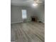 Bright living room with light gray walls, ceiling fan and decorative fireplace at 871 Clearwater Rd, Sharpsburg, GA 30277