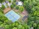 Overhead aerial view of the community's tennis courts and playground surrounded by trees and residential homes at 2967 Albright Commons, Kennesaw, GA 30144