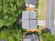 Aerial view of the property showing the house, driveway, and surrounding mature trees offering great privacy at 2967 Albright Commons, Kennesaw, GA 30144